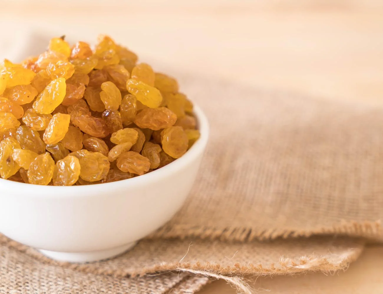 Golden and dark raisins spread out in a close-up view